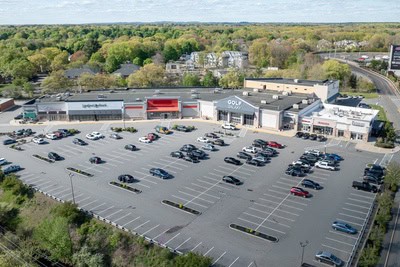 Large retail shopping center with spacious parking lot and multiple stores.